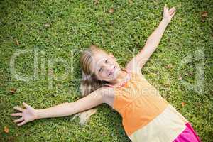 Young girl lying on grass