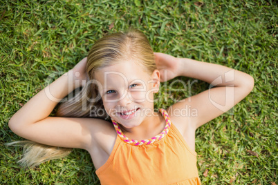 Young girl lying on grass