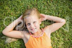 Young girl lying on grass