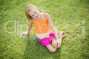 Young girl sitting on grass