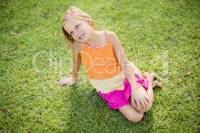 Young girl sitting on grass