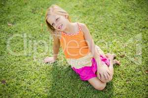 Young girl sitting on grass