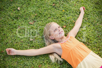 Young girl lying on grass