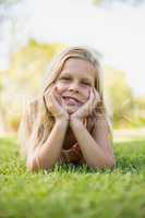 Young girl lying on grass