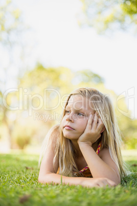 Young girl lying on grass