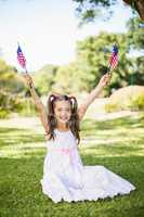 Cute girl holding American flags
