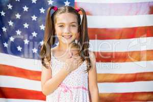 Young girl in front of American flag