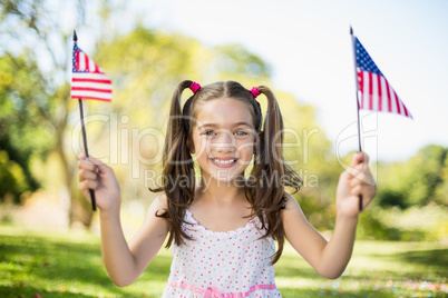 Cute girl holding American flags