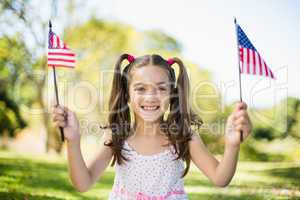 Cute girl holding American flags