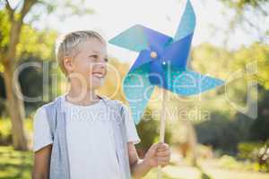 Boy holding a pinwheel in park