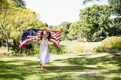 Young girl running with American flag