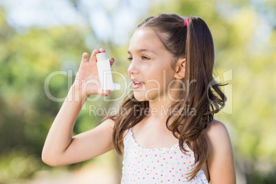 Girl using an asthma inhaler