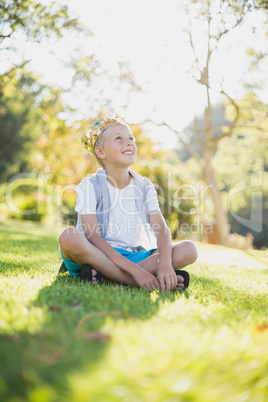 Young boy sitting in park