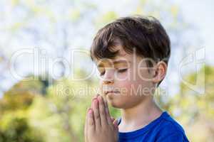 Boy praying with eyes closed