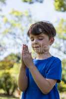 Boy praying with eyes closed