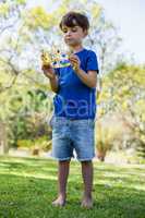 Boy holding a crown in park