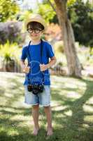 Boy posing with a camera around his neck
