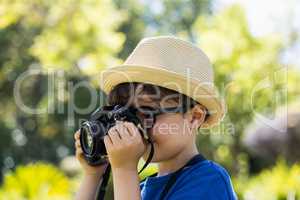 Young boy clicking a photograph from camera