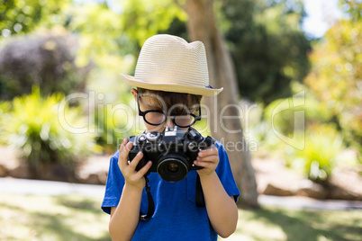 Young boy checking a photograph in camera