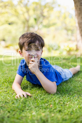 Boy holding a magnifying glass