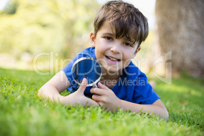 Boy holding a magnifying glass
