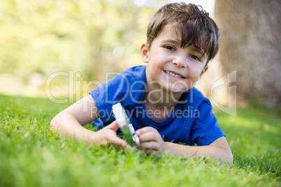 Boy holding a magnifying glass