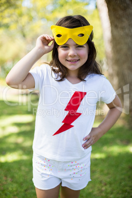 Young girl pretending to be a superhero