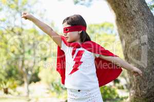 Young girl pretending to be a superhero