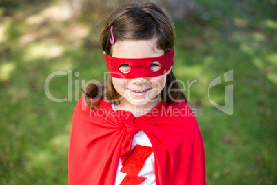 Young girl pretending to be a superhero