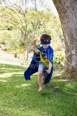 Young boy pretending to be a superhero