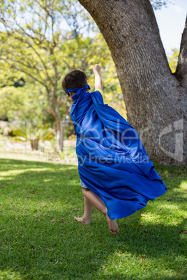 Young boy pretending to be a superhero