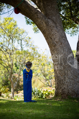 Young boy pretending to be a superhero