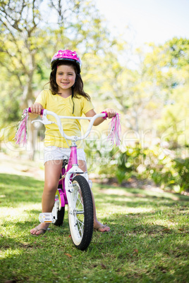 Smiling girl riding a bicycle