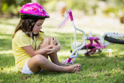 Young girl getting injured after falling from bicycle