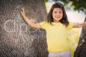 Young girl standing on tree trunk