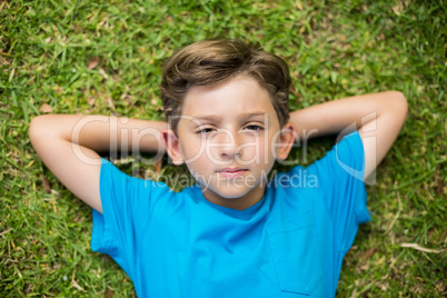 Young boy lying on grass