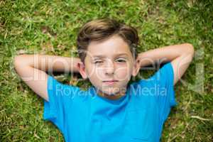 Young boy lying on grass