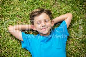 Young boy lying on grass