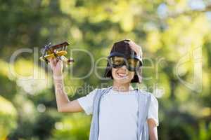 Boy playing with a toy aeroplane