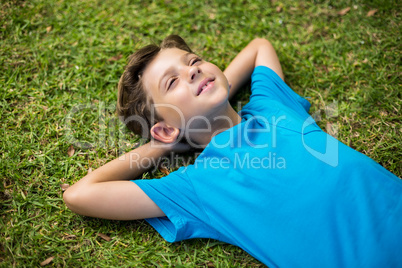 Young boy lying on grass