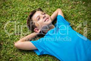 Young boy lying on grass