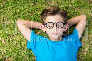 Young boy in spectacle sleeping in park