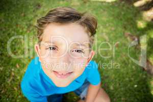 Young boy smiling at camera in park