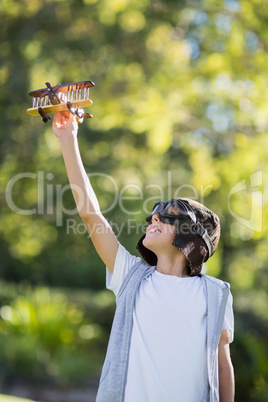 Boy playing with a toy aeroplane