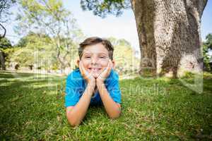 Smiling young boy lying on grass