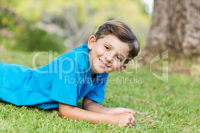 Smiling young boy lying on grass