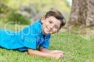 Smiling young boy lying on grass