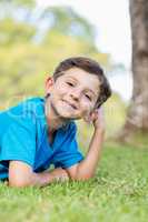 Smiling young boy lying on grass