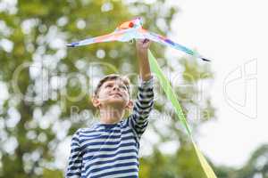 Boy holding a kite in park