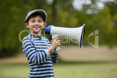 Smiling boy holding megaphone